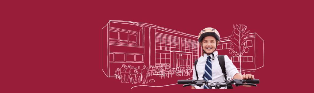 Smiling student with bike helmet in front of illustrated school building on maroon background.