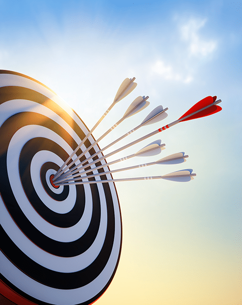 Arrows hitting a bullseye on a target under a clear sky, symbolizing precision and success in goal achievement.