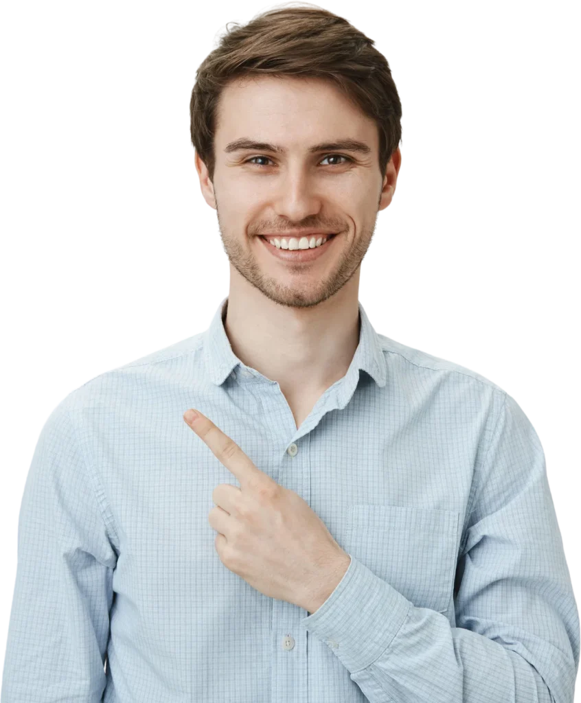 Smiling man in a blue shirt pointing to the side, isolated on a white background.