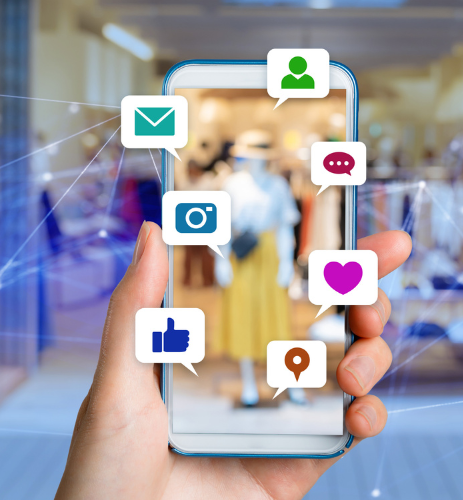 Hand holding smartphone with social media icons, connecting digital interactions in a retail environment.