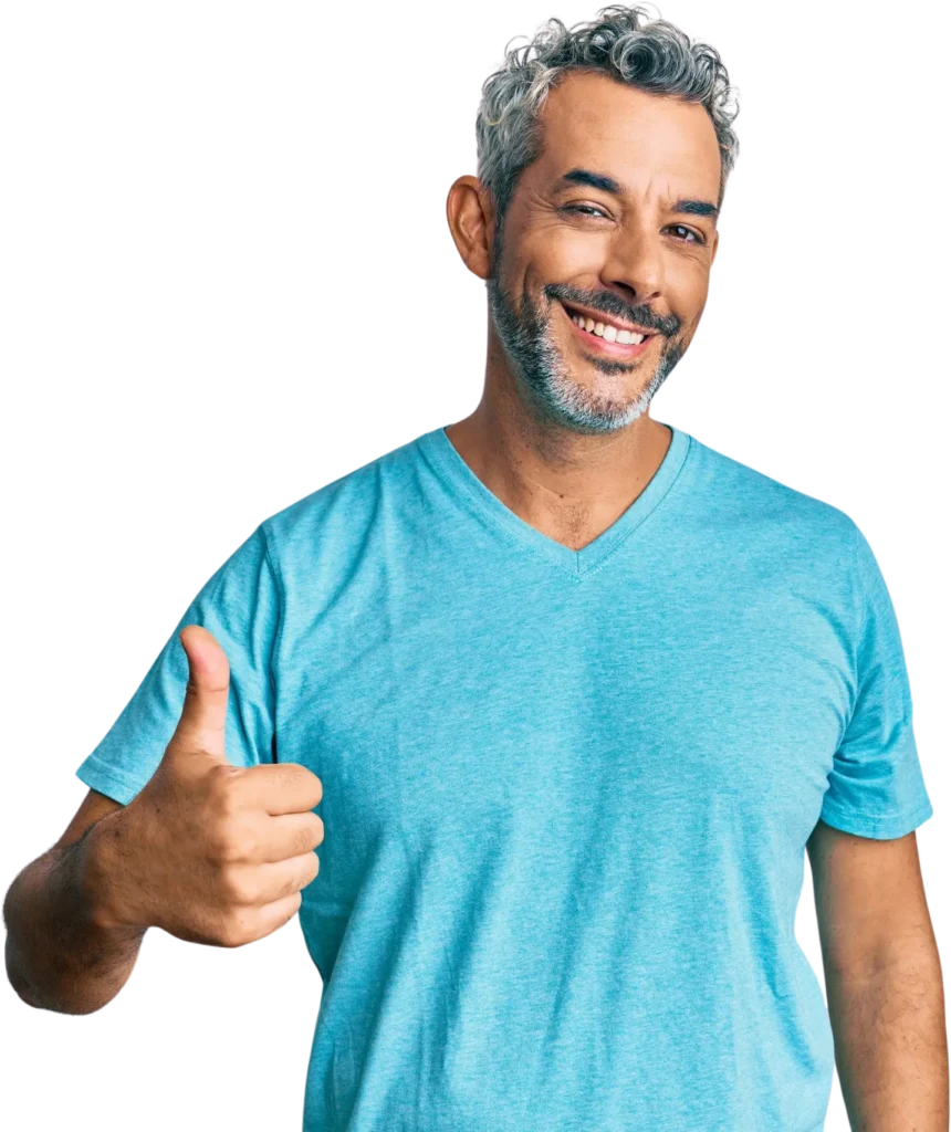 Man in blue shirt smiling and giving a thumbs up gesture, isolated on white background.