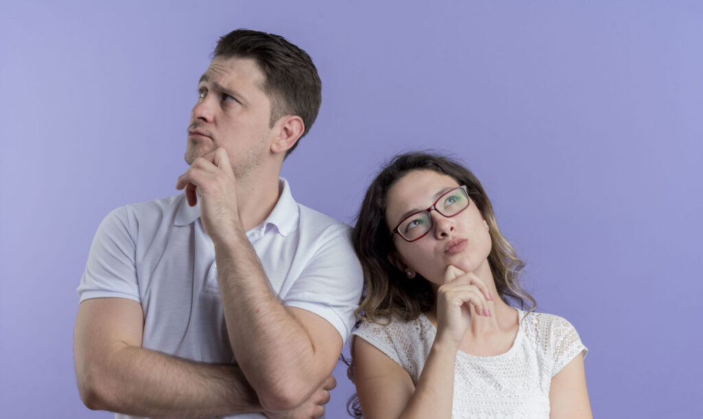Man and woman pondering ideas with thoughtful expressions against a purple background.