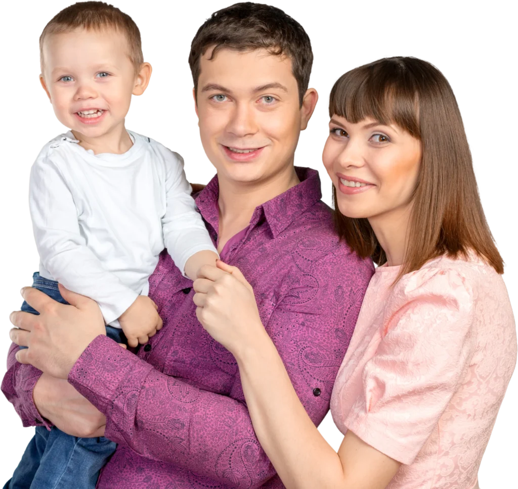 Happy family portrait with parents and child, smiling and posing together in colorful clothing.