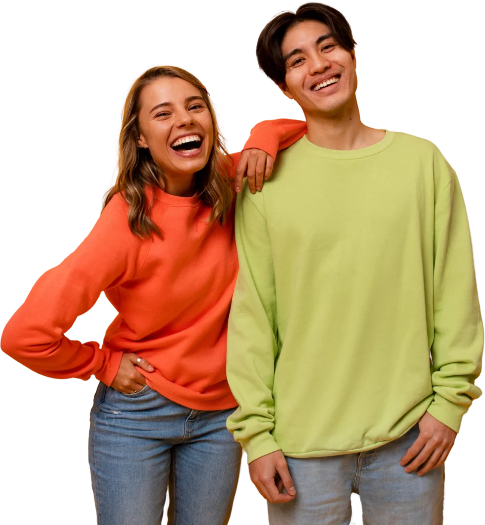 Smiling friends in colorful sweatshirts and jeans, showing happiness and casual style.
