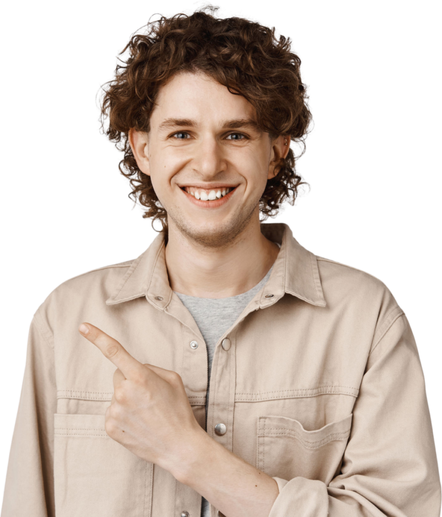 Smiling person with curly hair in casual beige shirt pointing to the side, isolated on white background.