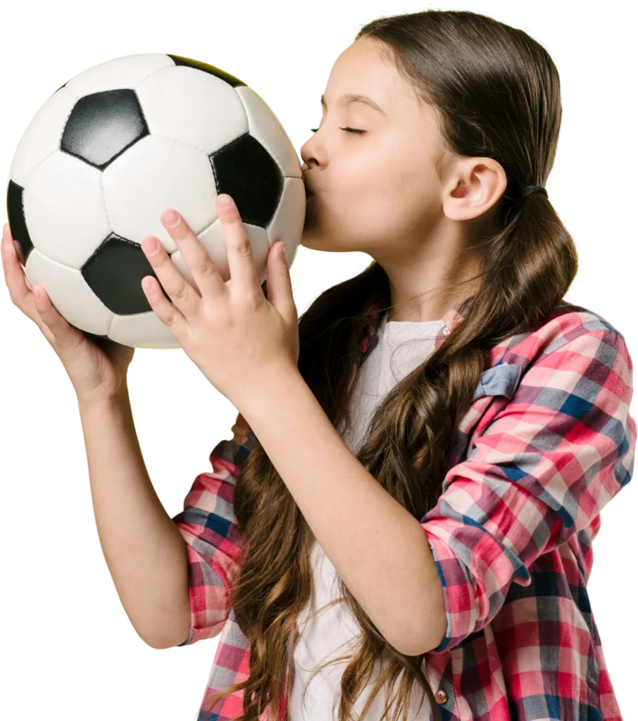 Girl in plaid shirt kissing a soccer ball, expressing love for the sport.
