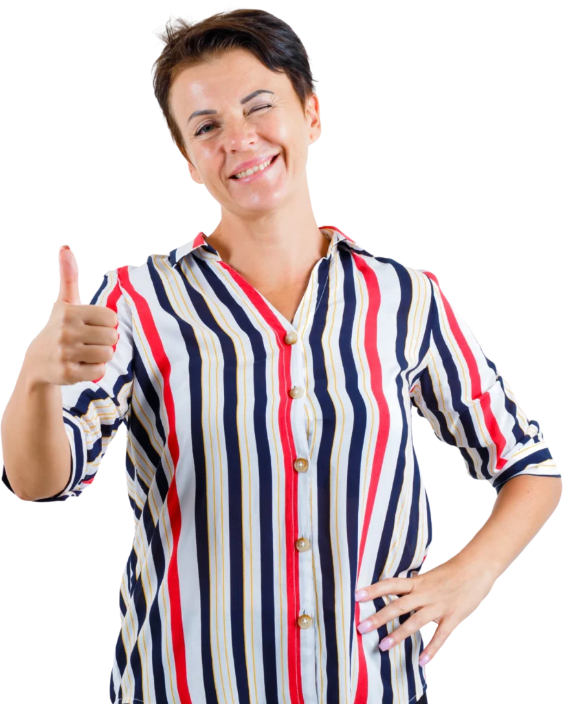 Smiling woman in a colorful striped shirt giving a thumbs up gesture, expressing positivity and approval.