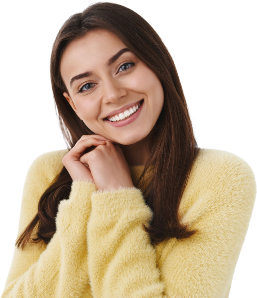 Smiling woman in a cozy yellow sweater, displaying happiness and warmth.